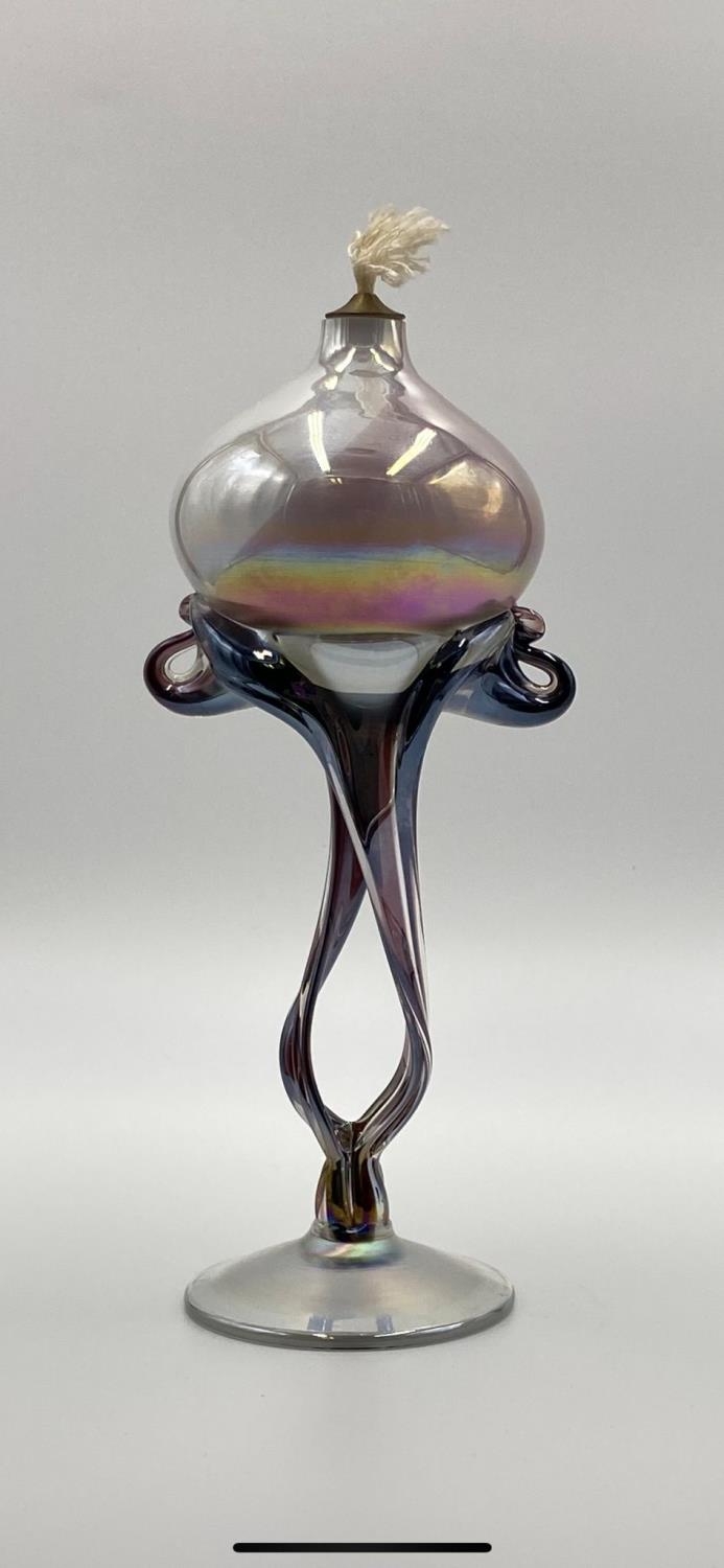 A stylish, hand blown, incandescent glass, artisan's oil lamp. Height 23cm.