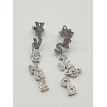 A pair of designer earrings by the iconic British designer Vivienne Westwood. Cast in silver tone