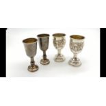 Two Silver Pairs of Silver Kiddush Cups. One Pair with Ornate grape decoration, the other