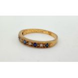 A 9K ROSE GOLD HALF ETERNITY RING WITH CHANNEL SET DIAMONDS AND SAPPHIRES. 1.8gms size M