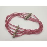 A White Metal and Ruby Quartz Four Strand Bracelet. 17cm.