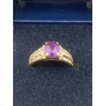 9 Carat Gold AMETHYST and DIAMOND RING ,having oval amethyst to top with diamond set triple