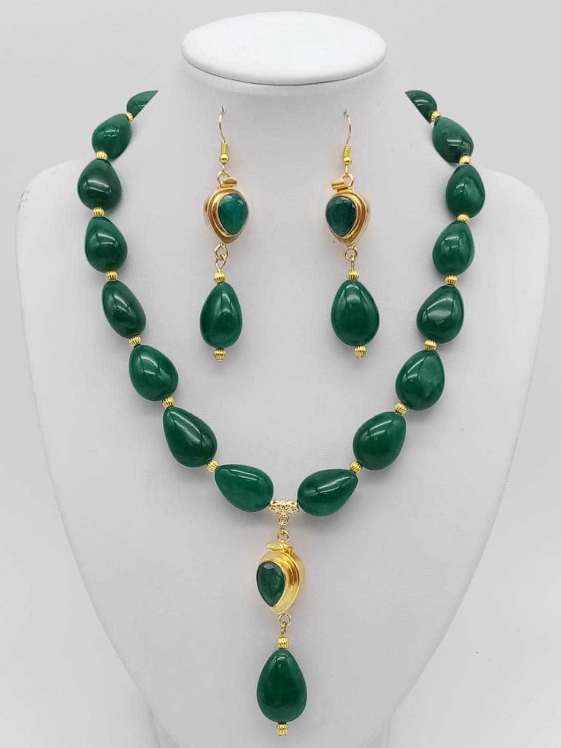 A sophisticated, tear drop, emerald beaded necklace and earrings set in a presentation box. Necklace