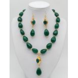 A sophisticated, tear drop, emerald beaded necklace and earrings set in a presentation box. Necklace
