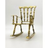 A POLISHED BRASS ROCKING CHAIR. 2.1kgs 24cms IN HEIGHT