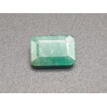2.11ct natural emerald gemstone with AnchorCert card and Safeguard valuation paper.