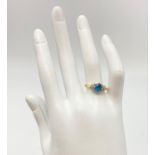 A 9K GOLD DRESS RING WITH A BLUE CENTRE STONE FLANKED BY SMALL DIAMONDS. 2.6gms size O
