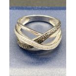 Silver crossover ring having light and dark Silver Marcasite to top .925 silver . size M