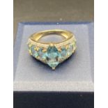 9 carat Gold Ring having Blue Aqua stones set in baguette and oval form to top. 3.9 grams. Size M1/2