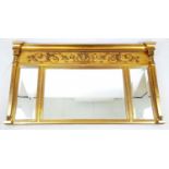 AN ORNATE MANTLE MIRROR WITH 3 BEZELLED GLASS MIRROR SECTIONS SET IN A GILDED FRAME DECORATED WITH