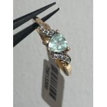 A 10k gold ( 417 purity probe) ring with aquamarine in triangle shape and diamonds; 1.8g; size N1/2