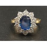 AN 18K DIAMOND AND SAPPHIRE OVAL CLUSTER RING WITH A 2.2CT SAPPHIRE AND 1.05CT DIAMONDS. 5.6gms size