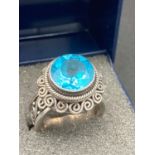 Silver and Topaz Ring having large Swiss Blue Topaz. Scroll detail to surround and band. 925