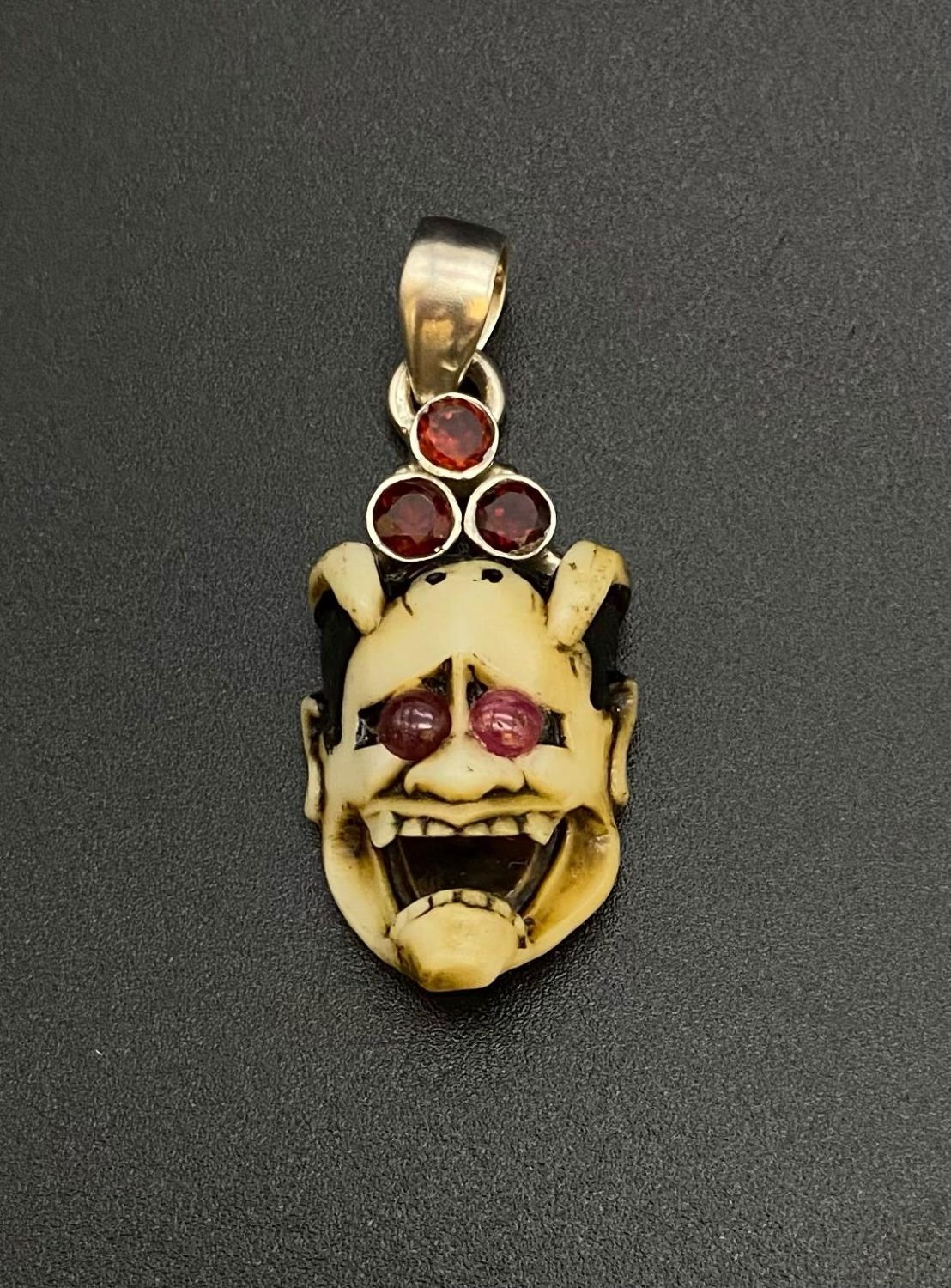 Meiji Period Carved Devil with Ruby and Garnet Silver Pendant.