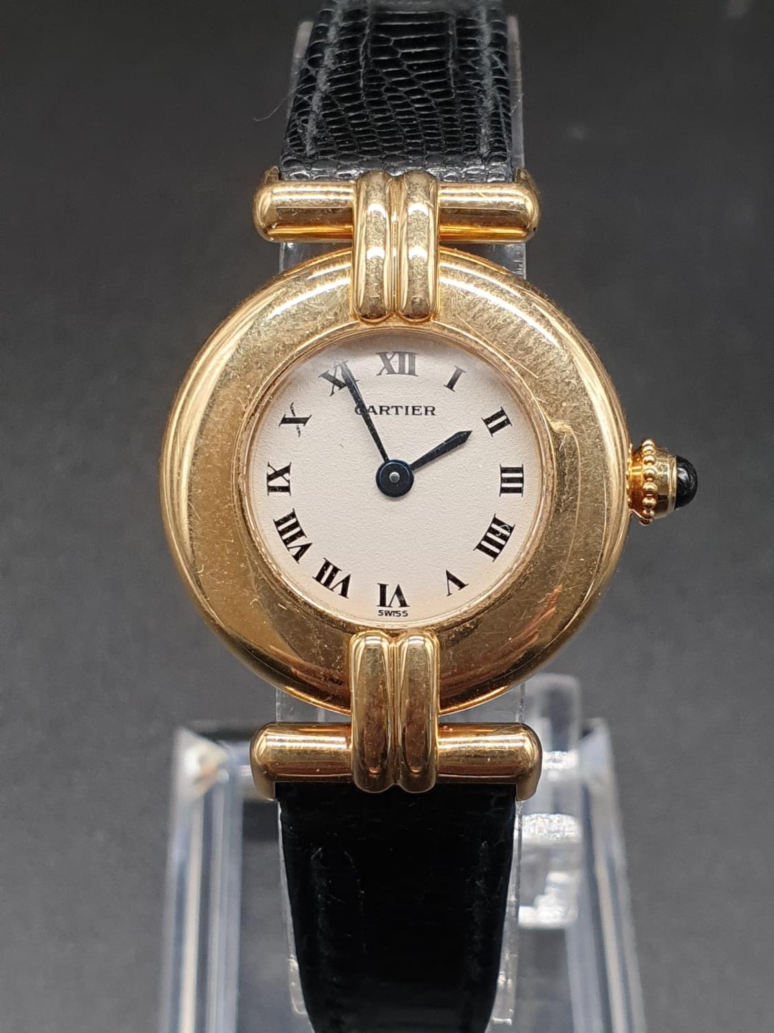 18k yellow gold Cartier quartz ladies watch, white round face and black leather strap