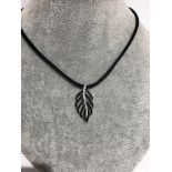 A leaf silver pendant with white and black CZ on silk cord chain 16 inches long; 5.4g