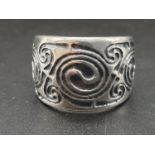 Sterling Silver patterned wide band ring. Size T and weighs 11.3g.