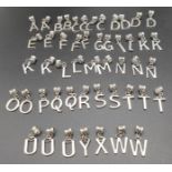 A BAG OF 50 ASSORTED LETTER PENDANTS/CHARMS IN WHITE METAL.