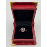 A VINTAGE 18K GOLD RUBY AND DIAMOND CLUSTER RING. 4.5gms size O
