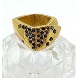 A DESIGNER RING BY ANTONIO MASSARUTTO MADE FROM BRASS AND BRONZE AND SET WITH BLACK ONYYX STONES.