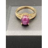 9 carat Gold ring having PURPLE MOONSTONE CABOCHON to top with diamond point to each shoulder. 4.