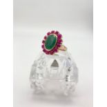 12cts Oval Emerald Ring with a Halo of Cabochon Rubies in Sterling Silver - Gold plate Finish.