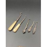 Antique Silver handled Victorian and Edwardian button hooks together with bone handled button hooks.