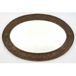 A VINTAGE WOODEN FRAMED OVAL MIRROR. 93 X 69cms
