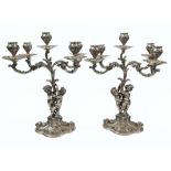 Antique pair of solid silver figural candelabra. Decorated with ornate cherubs and five candle-