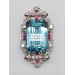 A nicely crafted pendant with a large central emerald cut aquamarine surrounded by diamonds (various