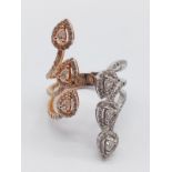 AN 18K ROSE GOLD AND WHITE GOLD PEAR SHAPED DIAMOND DRESS RING. 7.4 g set at size O, BUT ADJUSTABLE
