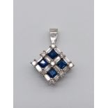 A 18K WHITE GOLD DIAMOND AND SAPPHIRE OFFSET SQUARE PENDANT. WEIGHT: 2.5g DROP: 2cm