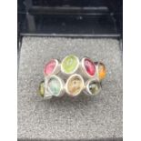 Silver multi gem set ring having various coloured semi precious stones set to top. 925 silver.