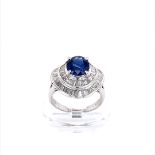 Platinum double halo sapphire and diamond ring, set with 1.9ct blue centre and approx 1ct baguette