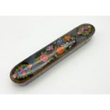 A VINTAGE PERSIAN LACQUERED PENCIL BOX WITH NICE FLORAL DECORATION. 22.5 X 4.5cms 92.4gms