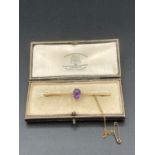 Antique 15 Carat Gold bar brooch late 19th early 20th century, having large oval amethyst centre