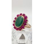 12cts Oval Emerald Ring with a Halo of Cabochon Rubies in Sterling Silver - Gold plate Finish.