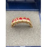 Ladies 9 carat GOLD and RED SPINEL ring having five faceted stones mounted to top in half hoop style