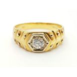 An 18 carat, yellow gold (hallmarked), Cartier style, gents ring, with a single brilliant cut