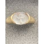 9 carat GOLD RING having cross of peace beneath clear stone top in intaglia style. 3.8 grams. Size