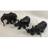 Three Carved Decorative Wooden Animals. An Elephant and Two Rhinos. 31cm longest piece. 17cm tallest