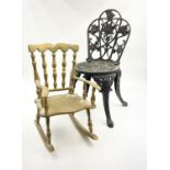 Two Vintage Dolls Chairs. A cast iron gilded rocking chair - 18 x 24cm. A decorative black cast iron