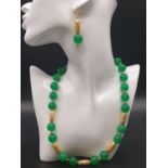 A high quality Chinese green jade and gold filled necklace and earring set in A presentation box.