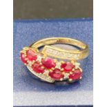 9 carat gold ring having a double row of Ruby coloured PINK SPINEL and DIAMONDS to top in