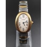 AN UNUSUAL CARTIER LADIES WATCH IN 18K GOLD AND STEEL BAINGOIRE, WITH OVAL FACE AND ROMAN NUMERALS