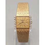 AN 18K GOLD PATEK PHILLIPE LADIES DRESS WATCH WITH 6 DIAMONDS FLANKING THE GOLD FACE. 23mm