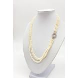 An Italian three row seed pearl necklace with an 18 carat white gold clasp with clear stones.