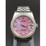 A LADIES ROLEX OYSTER PERPETUAL DATEJUST WITH UNUSUAL LILAC FACE, DIAMOND NUMERALS AND DIAMOND BEZEL