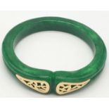 A modern high quality green jade bangle with sterling silver (hallmarked) and 22K yellow gold plated