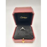 A CARTIER PLATINUM DIAMOND SOLITAIRE RING WITH A .31ct STONE, AS NEW IN ORIGINAL CARTIER BOX. 3.8gms